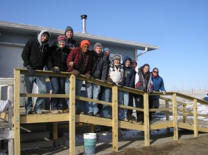 A group of students on a wheelchair ramp they constructed at Arlene High Horse’s house on Pine Ridge Indian Reservation in South Dakota during spring break. Photo by Lauren Young  