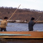 <p>Itelmen men pole a boat upriver.</p>