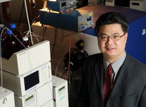 <p>Xudong Yao, assistant professor of chemistry, in his lab. Photo by Peter Morenus </p>