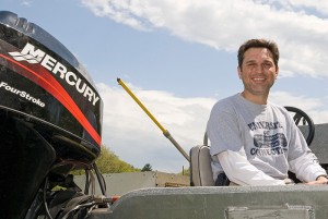 Jason Vokoun, assistant professor of natural resources and the environment, in a boat at Spring Manor Farm. Photo by Frank Dahlmeyer