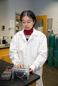 Baikun Li, assistant professor of civil and environmental engineering, tests the voltage of a microbial fuel cell. Photo by Jessica Tommaselli