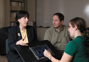 <p>Patricia Neafsey, left, professor of nursing, discusses the medication management software she developed with honors students Gregory Lutkus and Jessica Newcomb. Photo by Frank Dahlmeyer</p>