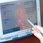 <p>Patients answer questions on a touch screen computer.</p>