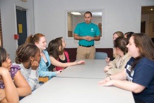 Miguel Colon, a program coordinator in Student Activities, leads a meeting of students in the Community Service living-learning community in Ellsworth residence hall. Photo by Jessica Tommaselli