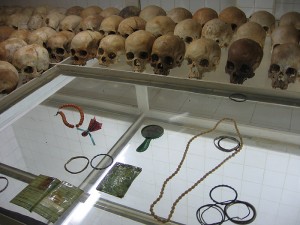 <p>Skulls of massacre victims, with Tutsi identity cards, bracelets, and necklaces, on display in the church at Nyamata where 10,000 people were killed. Only seven people survived. Photo by Valerie Love</p>