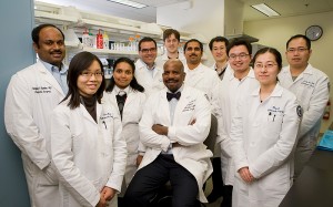 <p>Dr. Cato T. Laurencin, center, vice president for health affairs and dean of the medical school, with a team of researchers for whom he serves as a mentor. Photo by Lanny Nagler</p>