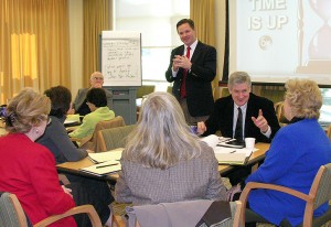 <p>Richard Lemons, assistant professor of educational leadership and director of the Institute for Urban School Improvement, conducts a leadership training session for school superintendents. Photo by Janice Palmer</p>