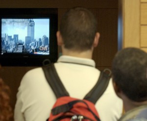 <p>Students watch CNN footage of the World Trade Center attack on Sept. 11, 2001 on a television at the Homer Babbidge Library. Archival photo by Peter Morenus</p>