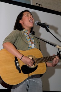 <p>Ashley Hamel, a student, plays the guitar during an open mic night, "Long River Live." The event was part of a week-long Metanoia Oct. 4-10 to raise awareness and prevent violence against women.</p>