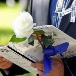 <p>A UConn football  player carries a white rose as he arrives for Jasper Howard's funeral. AP Photo/Alan Diaz</p>