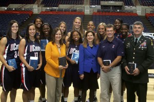 <p>House Majority Leader Denise Merrill, front row, in gold, Secretary of State Susan Bysiewicz, front row, in blue, Women’s Basketball head coach Geno Auriemma, and Col. Ron Welch of the Connecticut National Guard, with members of the Women’s Basketball team, during dedication ceremonies for the 2009 Blue Book in Gampel Pavilion on Oct. 15.</p>