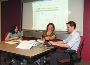 <p>Sandra Chafouleas, center, associate professor of educational psychology, speaks with members of her Direct Behavior Ratings research team, including Rose Jaffery, a graduate assistant, left, and Jamison Judd, Neag School webmaster. Photo by Janice Palmer</p>