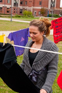 <p>Desiree DiLanno examines T-shirts in the Clothesline Project. Photo by Frank Dahlmeyer</p>