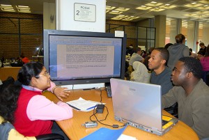 <p>A tutor works with students in the Quantitative Learning Center, or Q Center, part of the Learning Commons.</p>