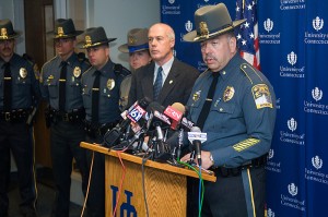 <p>Maj. Ronald Blicher of the UConn Police Department at the podium, and, second from right, Commissioner John A. Danaher III of the state Department of Public Safety. Photo by Daniel Buttrey</p>