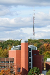 <p>The Biology/Physics Building, with the University radio tower in the background, as seen from the roof of the Student Union. Photo by Peter Morenus</p>