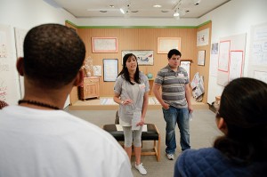 <p>Docents Julia Rockwell and Kevin Solorzano discuss an exhibition of Swedish Women's Arts with students in a First Year Experience class. Photo by Peter Morenus</p>