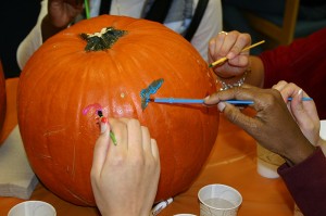 <p>Students from the African American Cultural Center decorate pumpkins with the residents of Journey House during one of their visits to the residential treatment center for teenage girls in Mansfield. Photo by Lillian L. Rhodes</p>