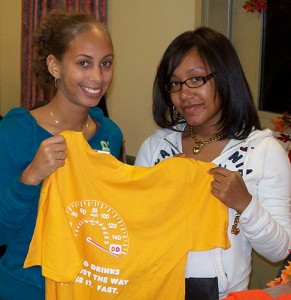 <p>Students Ava Rowland and Shalice Culbreath display a t-shirt they received from Dunkin Donuts in recognition of their volunteer efforts at Journey House. Photo by Ken Gwozdz</p>