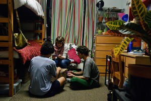 <p>From left, Tanner Burgdorf, a real estate and urban economics major, Danielle Lanslots, an environmental science major, and Trevor Biggs, also an environmental science major, in an EcoHouse dorm room. Photo by Jessica Tommaselli</p>