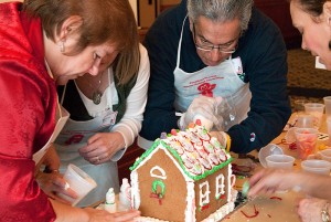 <p>Members of the Continuing Studies team work on their entry in the Gingerbread Competition. Photo by Frank Dahlmeyer</p>