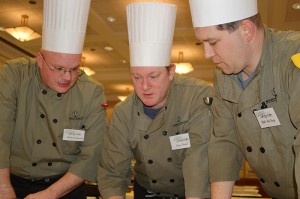 <p>Chefs from Team 6, Union Street Market, discuss their menu during the Boiling Point competition. From left, Richard Granja, Peter Devel, and Bill McKay. Photo by Gail Merrill</p>