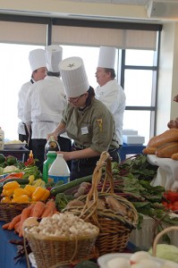 <p>A well stocked pantry supplied Boiling Point contestants with ingredients. Shown in the foreground is Katie Dumas from Team 2, Union Street Market. In the background are chefs representing Team 4 from University Catering. Photo by Gail Merrill</p>