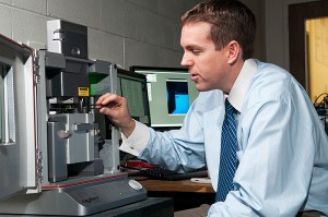<p>Bryan Huey, assistant professor of chemical, materials, and biomolecular engineering, in his lab in the Institute of Materials Science. Photo by Frank Dahlmeyer</p>