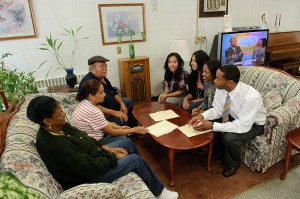 <p>Students from the School of Social Work meet with residents at Mary Mahoney Village in Hartford. From left, Erika Cruz, Lisa Figueroa, Detra Varner, and Christopher Parker. Photo by Peter Morenus</p>