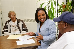 <p>Karen Bullock, associate professor of social work, meets with residents at Mary Mahoney Village in Hartford. Photo by Peter Morenus</p>