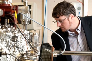 <p>Brian Willis, associate professor of chemical, materials, and biomolecular engineering, works with reactors in his lab. Photo by Frank Dahlmeyer</p>