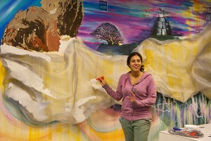 <p>Marela Zacarias, artist-in-residence at the Center for Latin American and Caribbean Studies, is painting a 10 x 18 foot mural  at the Center. Photo by Sean Flynn  </p>