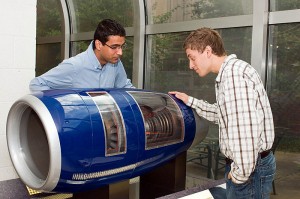 <p>UConn engineering students examine a quarter-scale cutaway model of the V2500 engine. Photo by Pablo Zevallos</p>