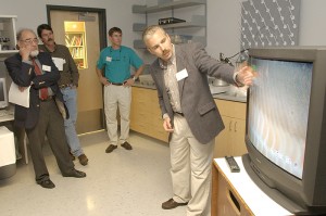 <p>J. Evan Ward, professor of marine sciences, shows visitors live video of research on mussels at his lab during a tour of the Marine Sciences Building. Photo by Peter Morenus</p>