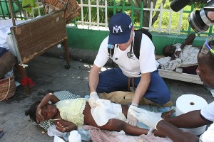 <p>Dr. Robert Fuller providing medical care to an earthquake survivor. Photo by Margaret Aguirre, International Medical Corps.</p>
