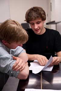 <p>Members of the UConn a cappella group the Conn Men discuss a song during rehearsal. Photo by Lauren Cunningham</p>