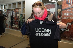 <p>Anna Stoltze, a human development and family studies major, picks up her senior t-shirt during the Grad Fair at the UConn Co-op. Photo by Margaret Malmborg</p>