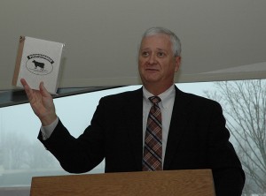 <p>Co-op manager Bill Simpson holds up an example of a recycled product called PooPoo Paper made from cow manure. Photo by Margaret Malmborg</p>