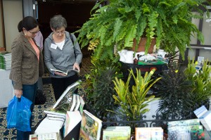<p>Attendees at the 8th annual Garden Conference peruse gardening books for sale. Photo by Daniel Buttrey</p>