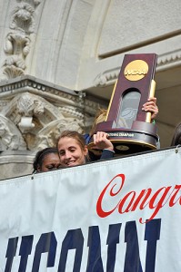 <p>Caroline Doty holds the trophy at the start of the parade in downtown Hartford to celebrate the Women's Basketball team's NCAA championship win. Photo by Peter Morenus</p>