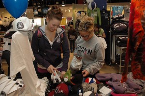 <p>Whitney Wodecki, left, and Taylor Dougherty, both first-year exploratory majors, look through the merchandise on a sale table  for a good buy. Photo by Margaret Malmborg</p>