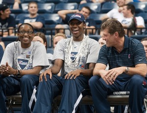 <p>Kalana Greene, left, and Tina Charles share a laugh with Coach Geno Auriemma during a video of 2009-2010 season highlights. Photo by Frank Dahlmeyer</p>