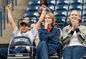 <p>Junior forward Maya Moore cheers during a video of 2009-2010 season highlights. Also shown are associate head coach Chris Dailey, center, and assistant coach Shea Ralph. Photo by Frank Dahlmeyer</p>
