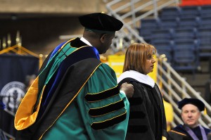 <p>Narissa Ramdhani is hooded by Lee Aggison Jr. as she receives an honorary degree during the CLAS Commencement ceremony at Gampel Pavilion. Photo by Peter Morenus</p>