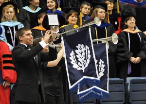 <p>Herald trumpeters play before the Graduate Commencement ceremony at Gampel Pavilion. Photo by Peter Morenus</p>