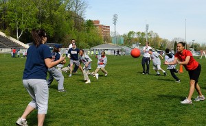 <p>Students from three Hartford schools play "Sharks and Minnows" with UConn students during the Husky Sport "Read and Raise Olympic Event". Photo by Jessica Tommaselli</p>