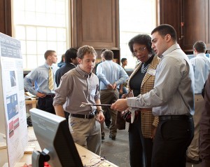 <p>School of Engineering students Peter Liaskas (EE) and Matthew Bonito (ME) discuss their project, "Staple Force Test Fixture," with an event attendee. Peter, Matthew and fellow students, James Li (EE) and Isaac Anderson (ME) developed the project for Covidien. This multi-disciplinary project consists of the design and execution of a prototype to determine the stapling force in a commercially available surgical stapler provided by Covidien. The students presented their prototype during the School of Engineering's Senior Design Demonstration day held in the Wilbur Cross building on Friday, April 30. Photo by Christopher LaRosa</p>