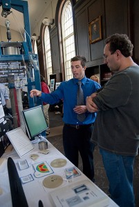 <p>Mechanical engineering major Brian Beahn explains his senior design project to a visitar at gather at Wilbur Cross Library's senior design project convention on April 30, 2010. Photo by Lauren Cunningham</p>