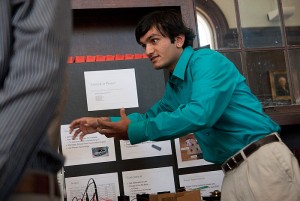 <p>Electrical Engineering major Hetul Patel explains to visitors his Electrocar senior design project at a convention in Wilbur Cross Library on April 30, 2010. Photo by Lauren Cunningham</p>