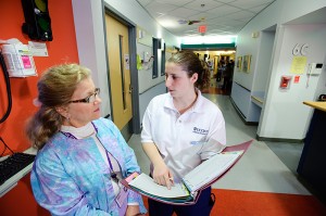 <p>Leah Goldberg, a nursing student, discusses a patient's treatment with Peggy Stolfi a nurse and School of Nursing  instructor, at Connecticut Children's Medical Center in Hartford. Photo by Peter Morenus</p>